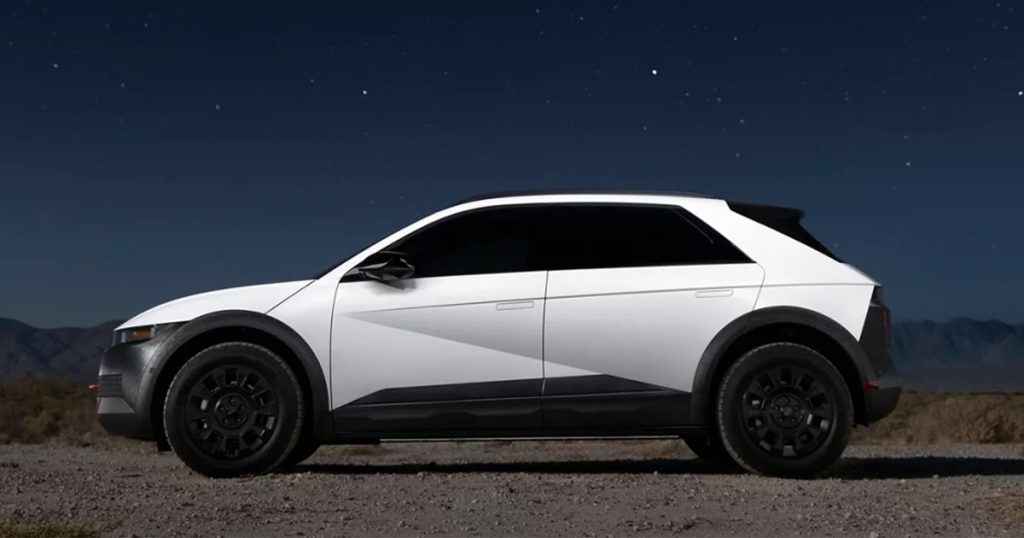 The Hyundai IONIQ 5 parked off-road under a starry sky at night.